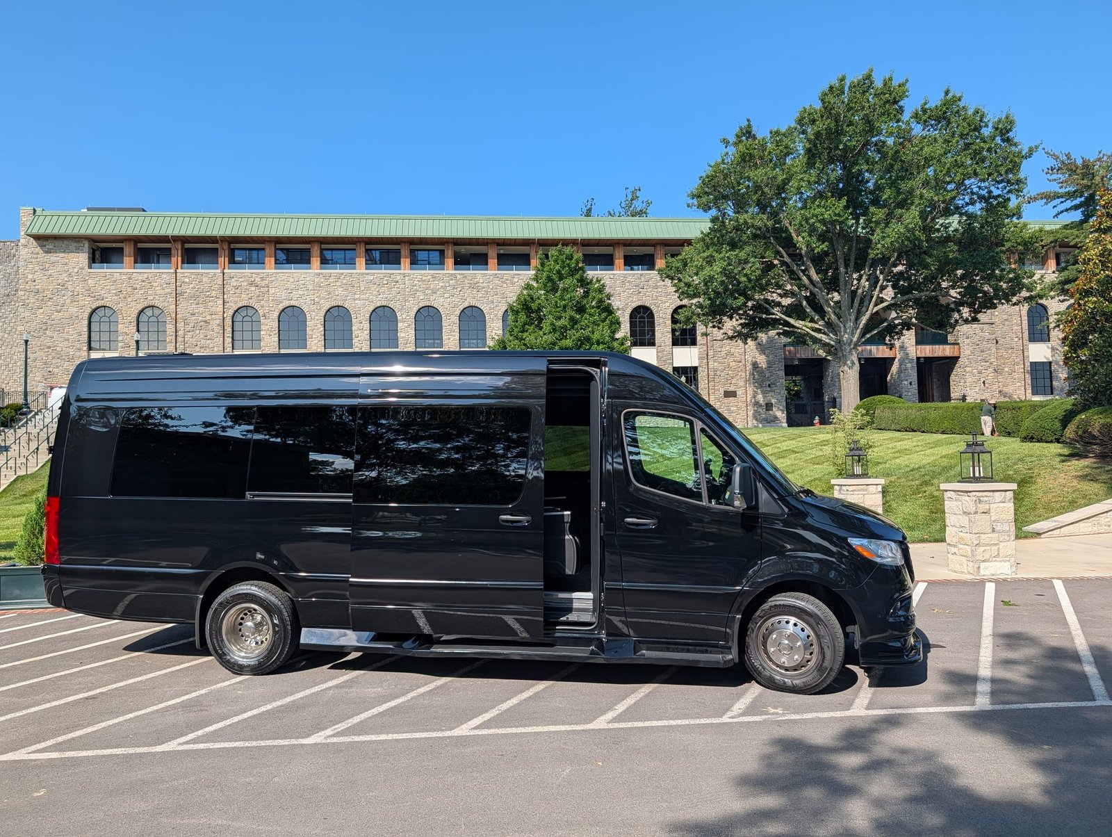 Sprinter van with the sliding door open and steps deployed